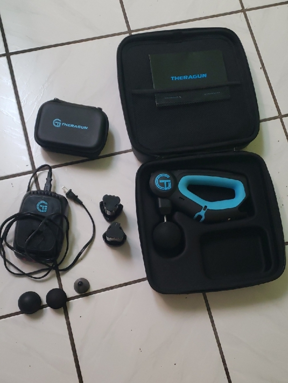 In great condition "Theragun" Massage Gun in Black & Teal with Case